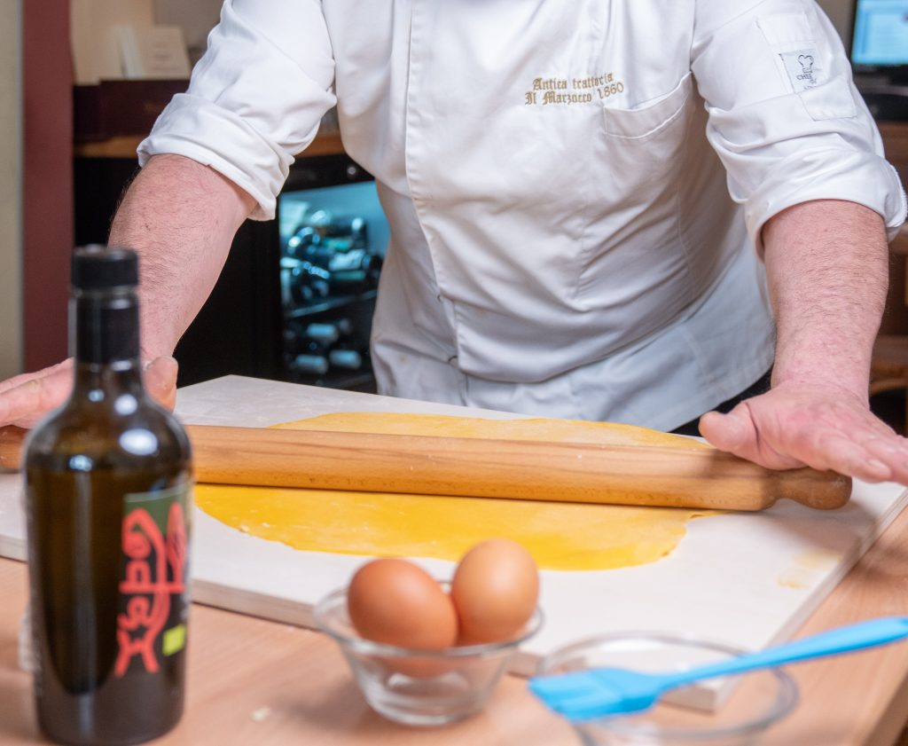 “Guests learning traditional Tuscan recipes in Montepulciano cooking class”