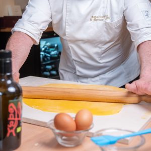 “Guests learning traditional Tuscan recipes in Montepulciano cooking class”